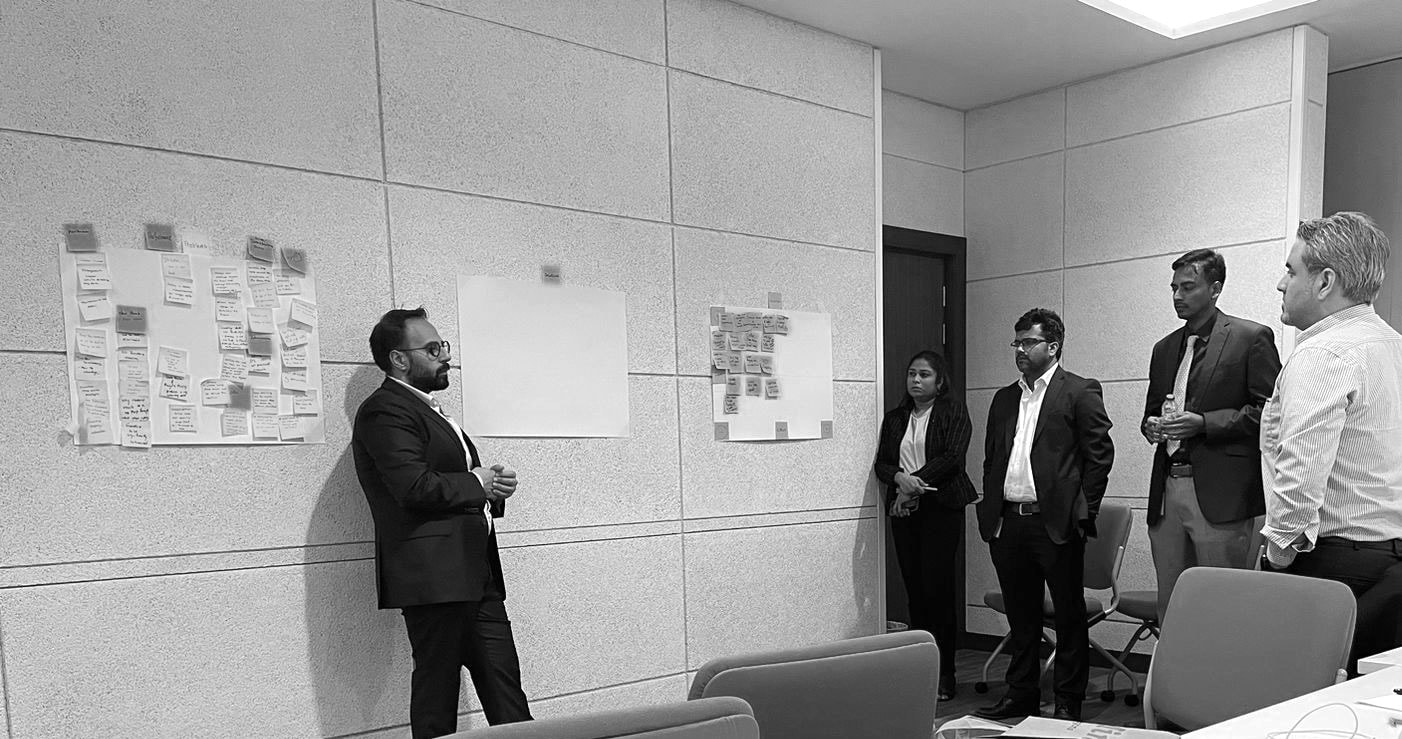 Design workshop with teams reviewing ideas on the wall